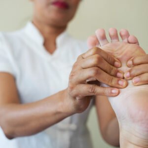 Close-up of woman doing foot massage at spa.